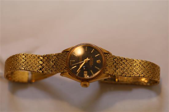A ladys 18ct gold Oyster Perpetual Datejust Superlative Chronometer, having black dial with baton numerals (bracelet repaired)